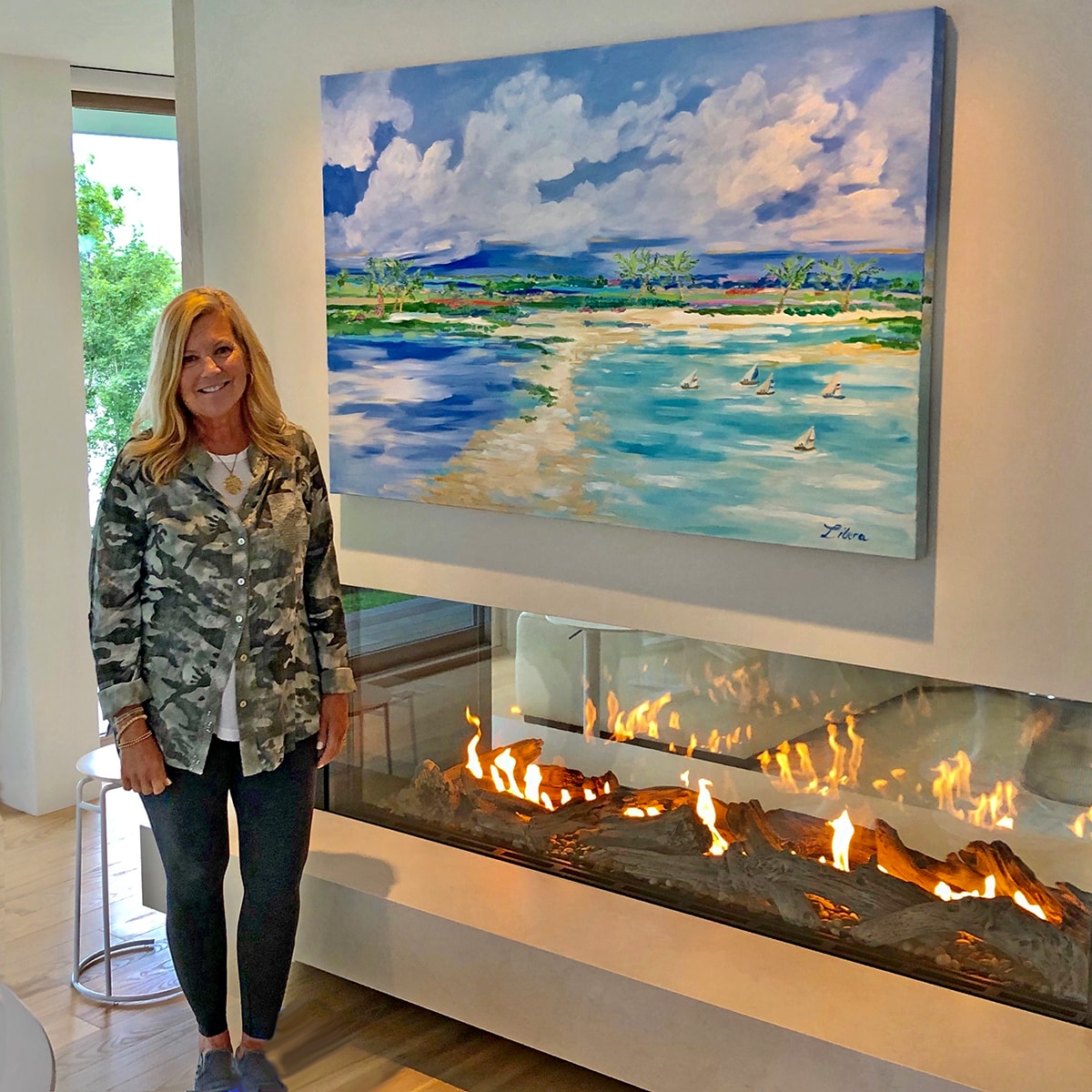 Heidi Libera with painting over fireplace